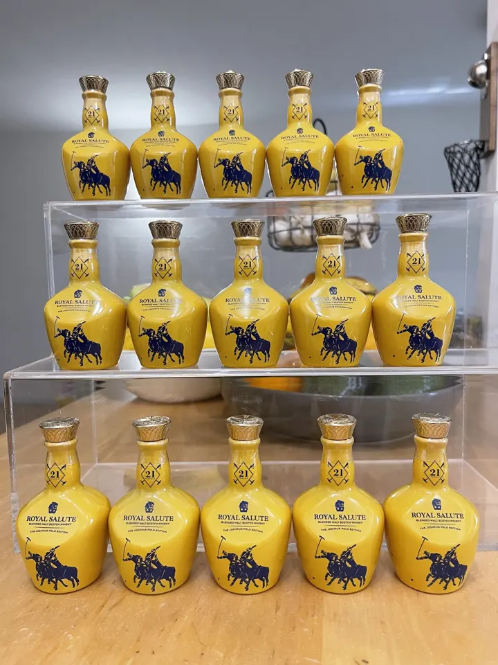 Fifteen yellow Royal Salute Jodhpur Polo Edition miniatures on three acrylic shelves
